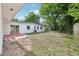 Backyard featuring a patio area, lush green trees and well-kept lawn space at 7301 Armstrong Rd, Orlando, FL 32810