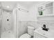 Modern bathroom featuring a walk-in shower with marble-look tile, vanity, and updated fixtures at 7301 Armstrong Rd, Orlando, FL 32810