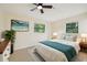Inviting bedroom with windows, ceiling fan, tile floors, and soothing decor at 7301 Armstrong Rd, Orlando, FL 32810