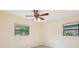 Bright bedroom featuring a ceiling fan, neutral walls, and dual windows for ample natural light at 7301 Armstrong Rd, Orlando, FL 32810