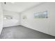 Spacious bonus room with ample natural light from multiple windows and a concrete floor at 7301 Armstrong Rd, Orlando, FL 32810
