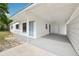 The carport leads to the front door and features decorative concrete blocks for semi-privacy at 7301 Armstrong Rd, Orlando, FL 32810