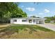 Charming single-story home with a well-manicured lawn, covered carport and freshly painted exterior at 7301 Armstrong Rd, Orlando, FL 32810