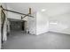 Spacious garage with an overhead door, ample storage, and a neutral concrete floor at 7301 Armstrong Rd, Orlando, FL 32810