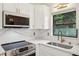 Kitchen detail featuring updated cabinets, stainless steel appliances, and bright lighting at 7301 Armstrong Rd, Orlando, FL 32810