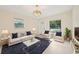 Living room featuring modern decor, large windows, and tile flooring, perfect for entertaining guests at 7301 Armstrong Rd, Orlando, FL 32810