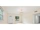 Bright, open living room with a decorative chandelier, tile flooring, and a front-facing window at 7301 Armstrong Rd, Orlando, FL 32810