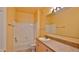 Well-lit bathroom features a shower and tub combination with tile and a vanity sink at 830 Airport Rd # 115, Port Orange, FL 32128