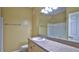 Well-lit bathroom with a single sink, vanity and white tiled shower at 830 Airport Rd # 115, Port Orange, FL 32128