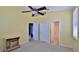 Bright bedroom featuring warm yellow walls and three doorways leading to different rooms at 830 Airport Rd # 115, Port Orange, FL 32128