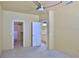 Bright bedroom featuring doorways to the bathroom and a walk-in closet at 830 Airport Rd # 115, Port Orange, FL 32128