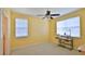 Cozy bedroom with two windows and a sewing machine table at 830 Airport Rd # 115, Port Orange, FL 32128