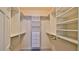 Well-organized walk-in closet with multiple shelves, drawers, and hanging rods at 830 Airport Rd # 115, Port Orange, FL 32128