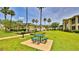 Community picnic area featuring a charcoal grill and table with benches at 830 Airport Rd # 115, Port Orange, FL 32128