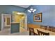 Cozy dining room with chandelier lighting next to the kitchen at 830 Airport Rd # 115, Port Orange, FL 32128