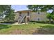 Inviting two-story condo with lush landscaping and stairs leading to the second level at 830 Airport Rd # 115, Port Orange, FL 32128
