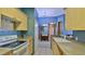 Well-lit kitchen featuring ample counter space and a view into the dining room at 830 Airport Rd # 115, Port Orange, FL 32128