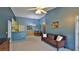 Open-concept living room with adjacent dining area, with neutral walls and flooring at 830 Airport Rd # 115, Port Orange, FL 32128