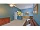 Open-concept living room and dining area with warm-toned walls and neutral carpeting at 830 Airport Rd # 115, Port Orange, FL 32128