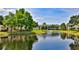 Scenic view of a tranquil pond with a fountain, surrounded by lush landscaping and inviting residential buildings at 830 Airport Rd # 115, Port Orange, FL 32128