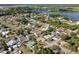 An aerial view shows the community located near a serene lake surrounded by lush greenery and mature trees at 831 Lindley Blvd, Deland, FL 32724