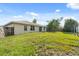 Large backyard surrounded by grass and a wooden fence for privacy at 831 Lindley Blvd, Deland, FL 32724