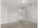 Cozy bedroom featuring neutral carpet, fresh paint, closet with double doors, and comfortable lighting at 831 Lindley Blvd, Deland, FL 32724