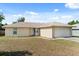 Exterior view of house with a well-maintained yard and two car garage at 831 Lindley Blvd, Deland, FL 32724