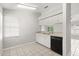 Practical kitchen featuring a tile floor, white cabinets, and updated appliances with an adjacent breakfast nook at 831 Lindley Blvd, Deland, FL 32724