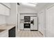 Well-lit kitchen with white appliances, modern cabinetry, tile floors, and ample counter space at 831 Lindley Blvd, Deland, FL 32724