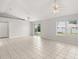 Spacious living room with neutral paint, tiled floors, ceiling fans, and sliding doors to the backyard at 831 Lindley Blvd, Deland, FL 32724