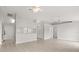 Open-concept living area with tiled flooring, ceiling fans, and a breakfast bar connecting to the kitchen at 831 Lindley Blvd, Deland, FL 32724