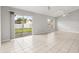 Bright living room with tiled flooring, sliding glass doors to the patio, ceiling fan, and neutral paint at 831 Lindley Blvd, Deland, FL 32724