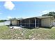 Home's backyard featuring a spacious screened patio, perfect for outdoor gatherings at 8625 Shady Glen Dr, Orlando, FL 32819