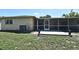 Exterior view of the home, highlighting the screened patio and well-maintained backyard at 8625 Shady Glen Dr, Orlando, FL 32819