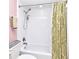 Clean white bathroom features a shower/tub with leaf-patterned shower curtain and modern fixtures at 8625 Shady Glen Dr, Orlando, FL 32819