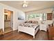 Comfortable bedroom with bathroom access, a ceiling fan, and a sun-filled window at 8625 Shady Glen Dr, Orlando, FL 32819