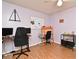 Bedroom or office features hardwood floors, a ceiling fan, and ample desk space for work or study at 8625 Shady Glen Dr, Orlando, FL 32819