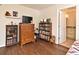 Bedroom with hardwood floors, bathroom access, and vintage furnishings at 8625 Shady Glen Dr, Orlando, FL 32819