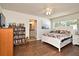 Comfortable bedroom with bathroom access, ceiling fan, and a bookshelf at 8625 Shady Glen Dr, Orlando, FL 32819