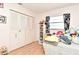 Bedroom showcasing hardwood floors, a window for natural light, and a spacious closet, providing comfort and functionality at 8625 Shady Glen Dr, Orlando, FL 32819
