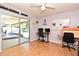 Bedroom or office with hardwood floors, a ceiling fan, and sliding doors leading to an outdoor patio at 8625 Shady Glen Dr, Orlando, FL 32819