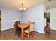 Quaint dining area with a wood table set for four at 8625 Shady Glen Dr, Orlando, FL 32819