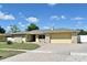 Charming single-story home with a paved driveway, two-car garage, and manicured landscaping at 8625 Shady Glen Dr, Orlando, FL 32819
