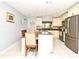 Bright kitchen featuring a dining table, stainless steel appliances, and stylish countertops at 8625 Shady Glen Dr, Orlando, FL 32819