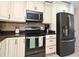 Well-lit kitchen with modern appliances, custom cabinets, and stylish backsplash at 8625 Shady Glen Dr, Orlando, FL 32819