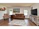 Inviting living room with wood floors, large windows, and modern decor at 8625 Shady Glen Dr, Orlando, FL 32819