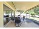 Covered screened patio is furnished with a table and chairs, perfect for outdoor dining at 8625 Shady Glen Dr, Orlando, FL 32819