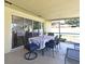 Covered screened patio is furnished with a table and chairs, perfect for outdoor dining at 8625 Shady Glen Dr, Orlando, FL 32819