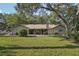 Spacious backyard with a lush lawn, shaded patio, perfect for outdoor entertaining and relaxation at 921 Torchwood Dr, Deland, FL 32724
